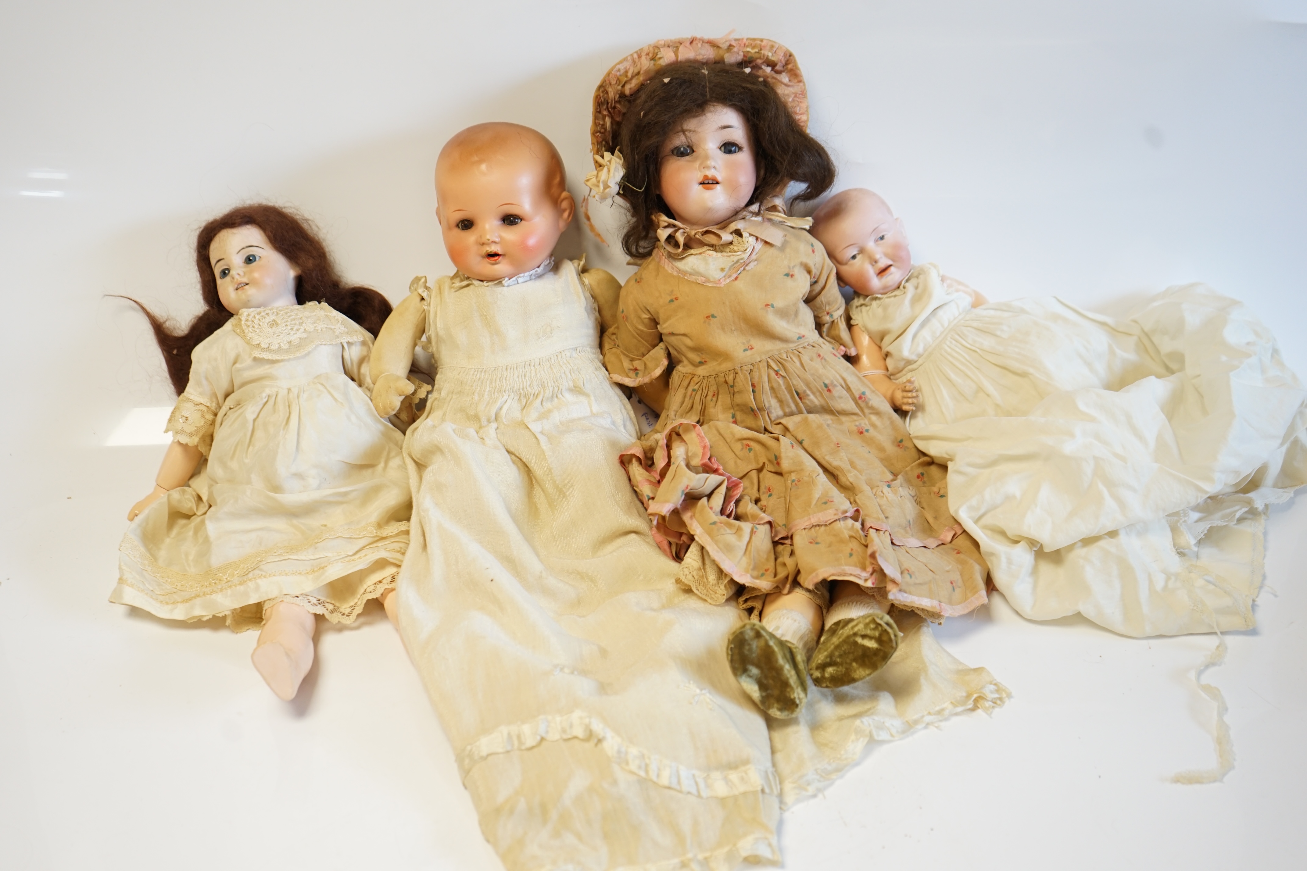 An AM390 doll, 47cm high, an Einco baby doll, 25cm, and a composition baby A.M. soft body modern jointed doll (4). Condition - fair